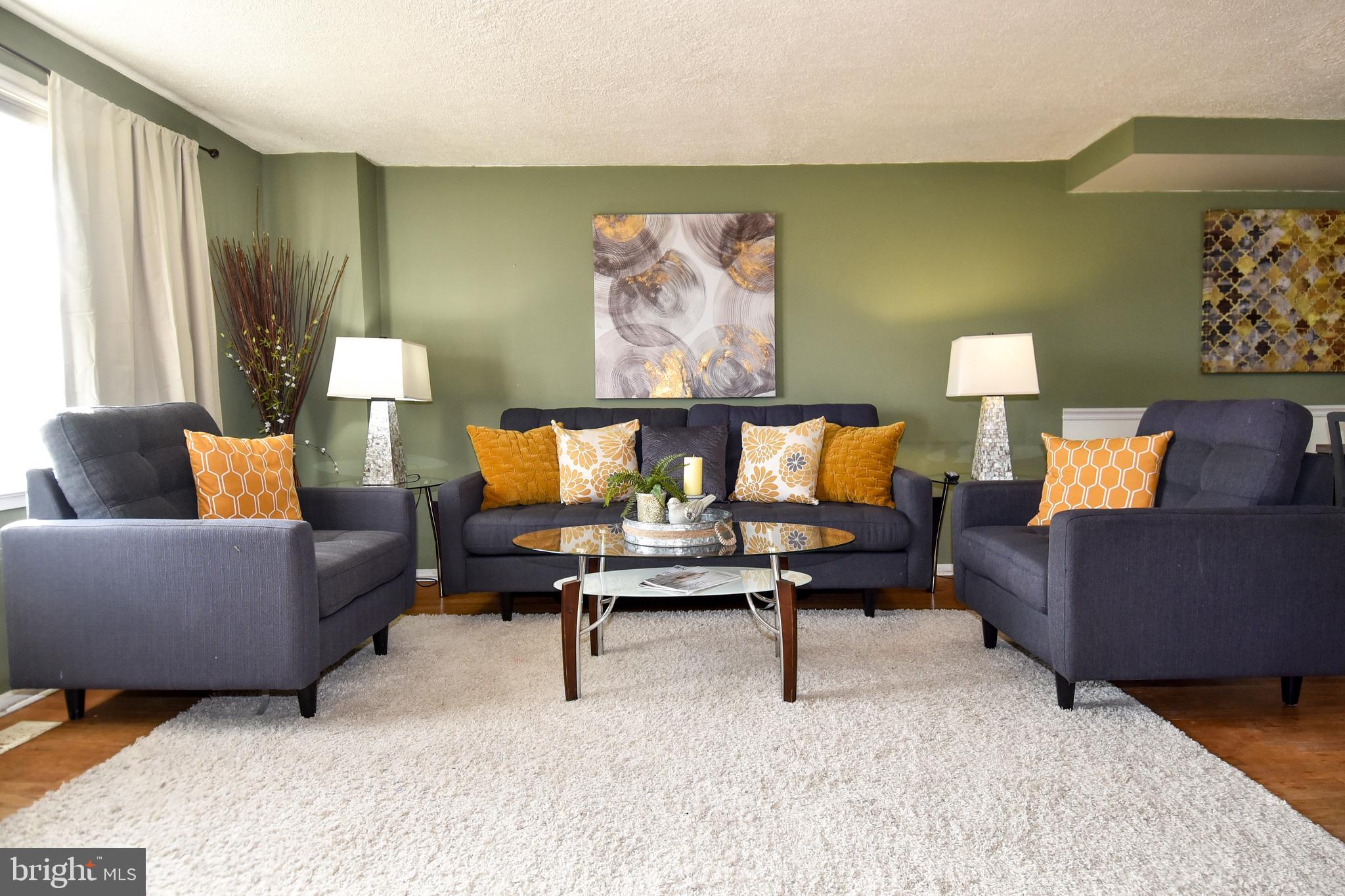 1024 Grovehill Road Baltimore, MD 21227 - Photo 3 of 39 a living room with furniture and a lamp