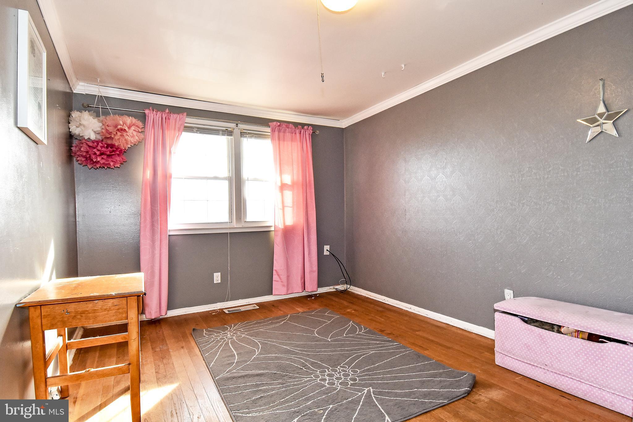 1024 Grovehill Road Baltimore, MD 21227 - Photo 22 of 39 a bedroom with a bed and a window