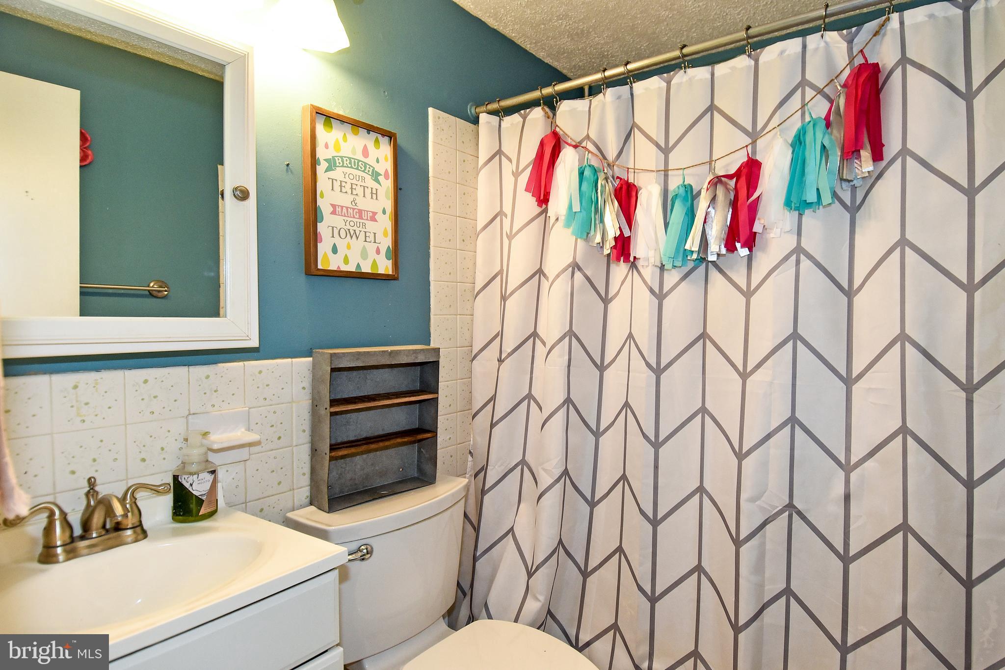 1024 Grovehill Road Baltimore, MD 21227 - Photo 27 of 39 a bathroom with a sink toilet and shower