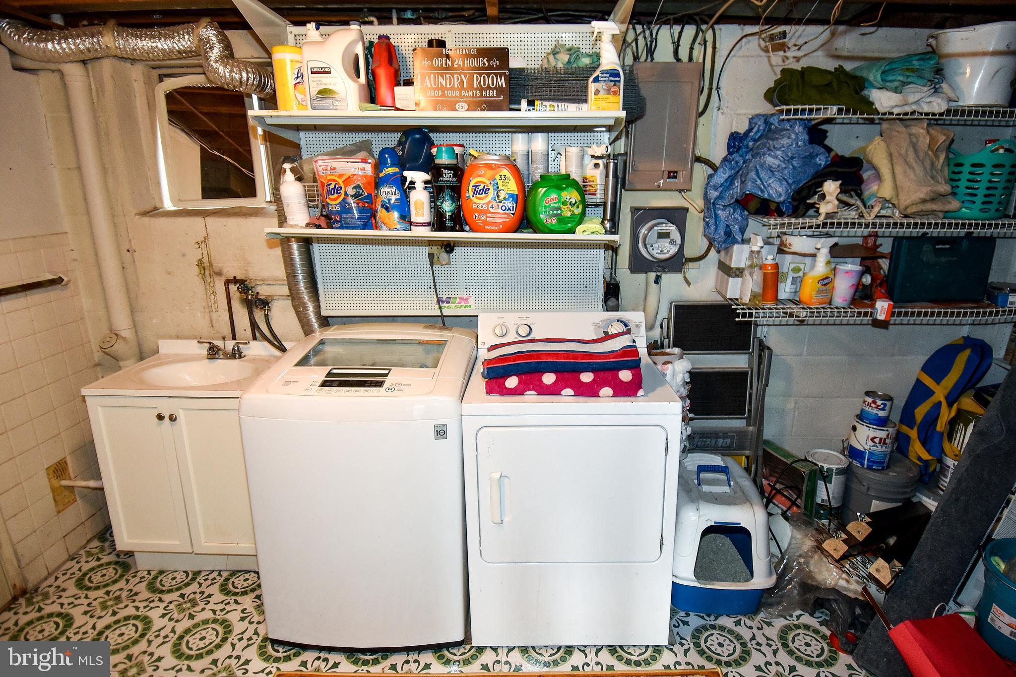 1024 Grovehill Road Baltimore, MD 21227 - Photo 28 of 39 a utility room with fridge dryer and bicycles