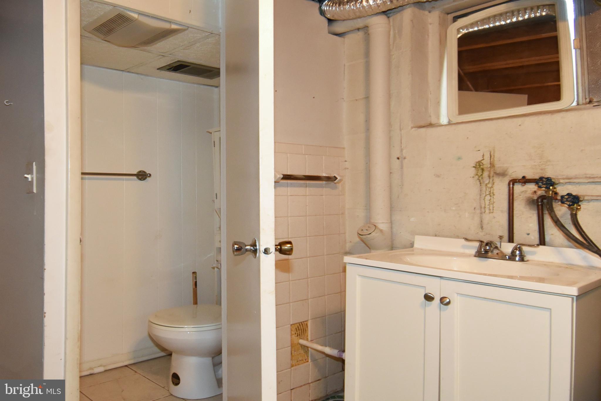 1024 Grovehill Road Baltimore, MD 21227 - Photo 30 of 39 a bathroom with a sink toilet and shower