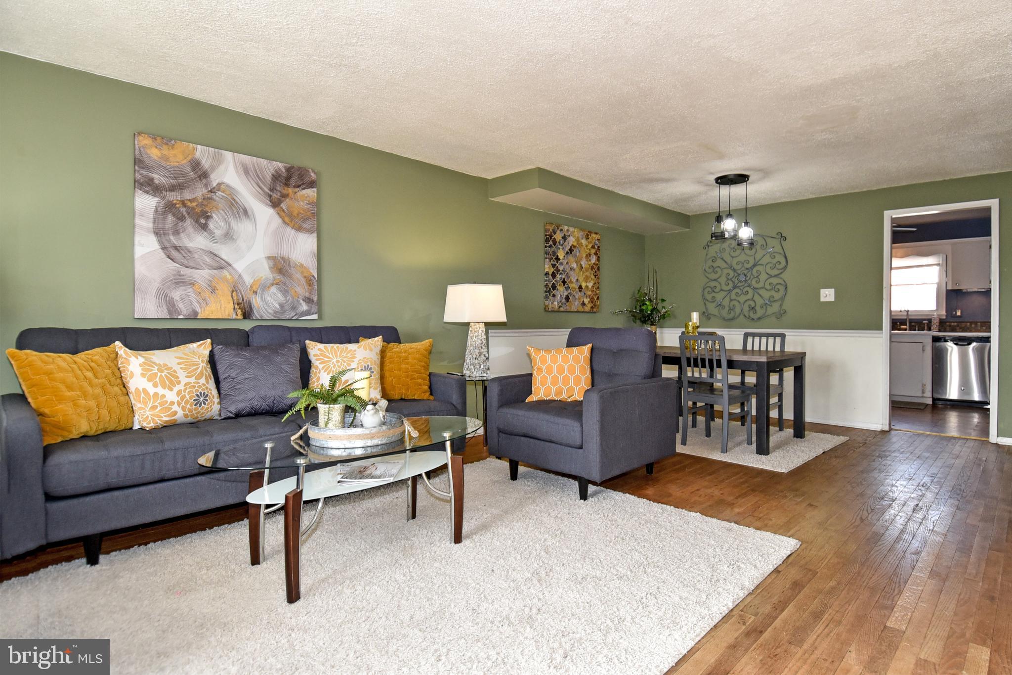 1024 Grovehill Road Baltimore, MD 21227 - Photo 4 of 39 a living room with furniture and wooden floor