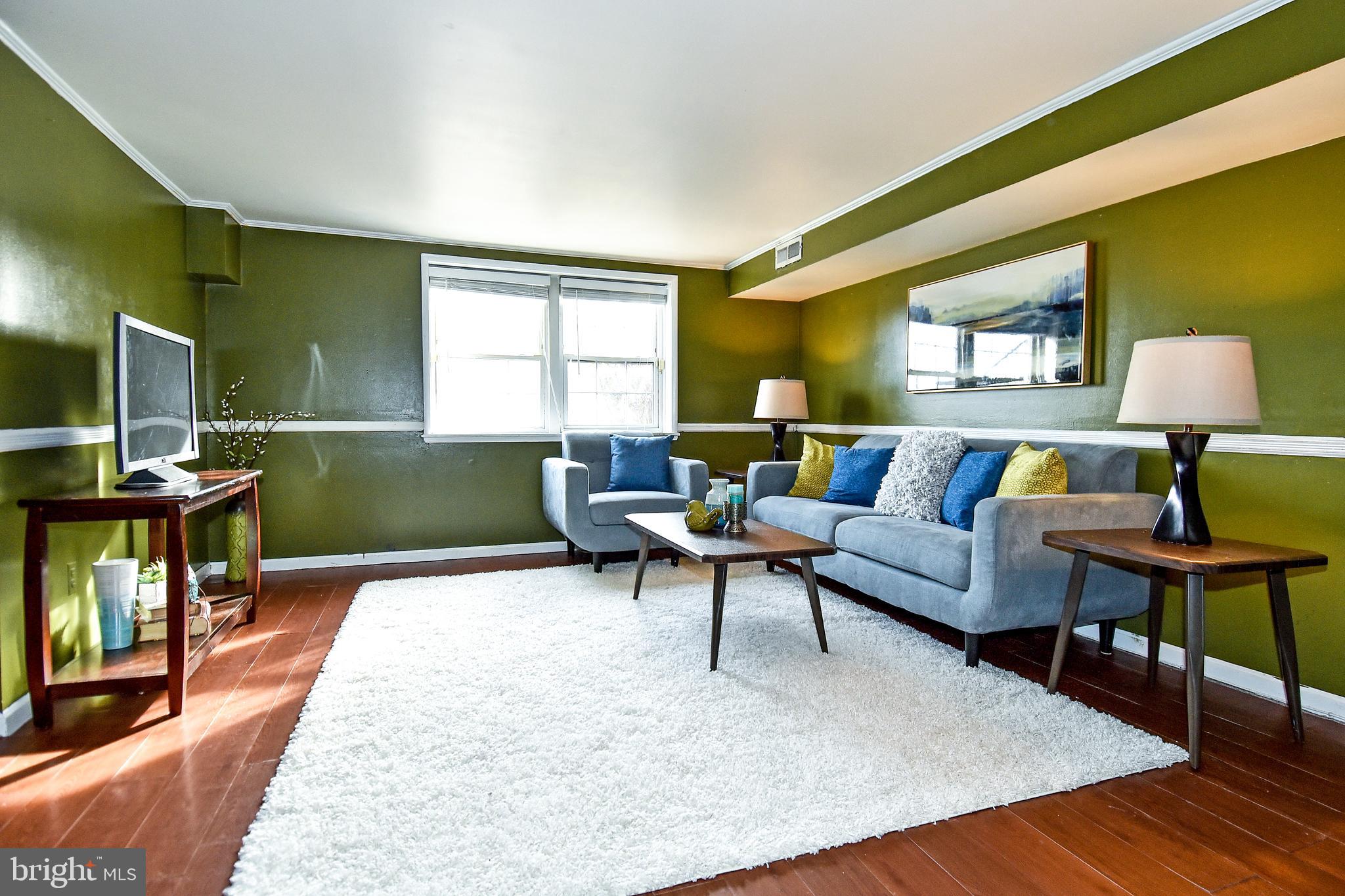 1024 Grovehill Road Baltimore, MD 21227 - Photo 32 of 39 a living room with furniture and a wooden floor