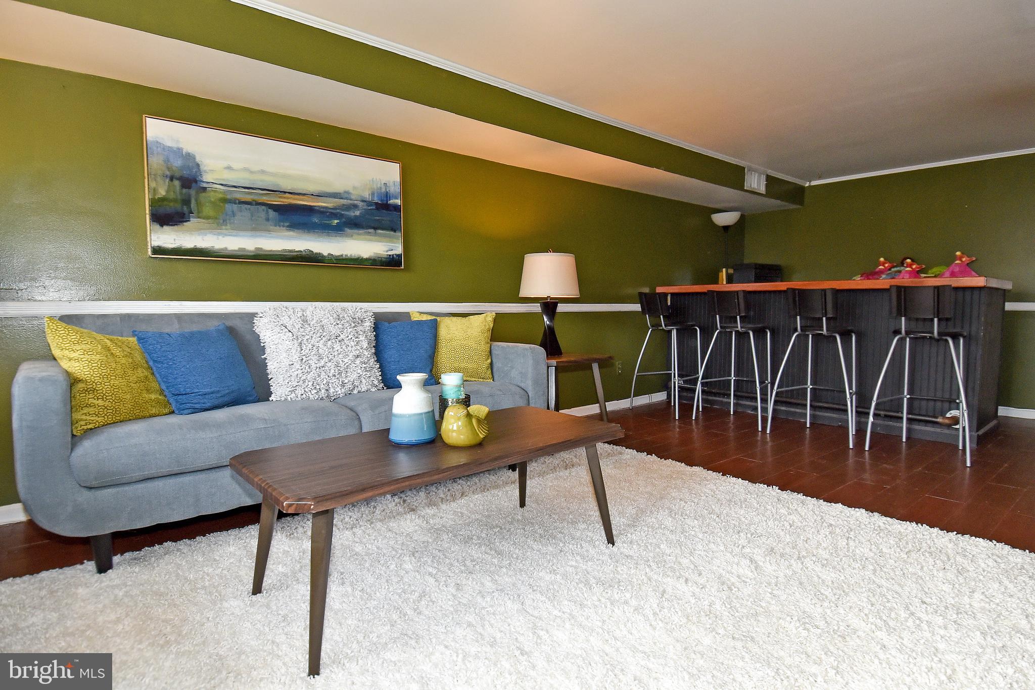 1024 Grovehill Road Baltimore, MD 21227 - Photo 34 of 39 a living room with furniture and a wooden floor
