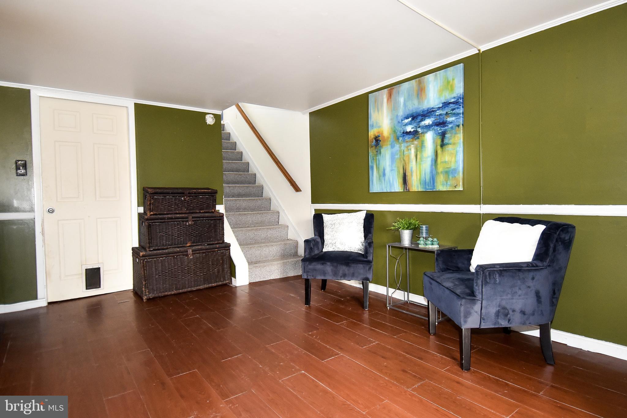1024 Grovehill Road Baltimore, MD 21227 - Photo 35 of 39 a living room with furniture and a wooden floor