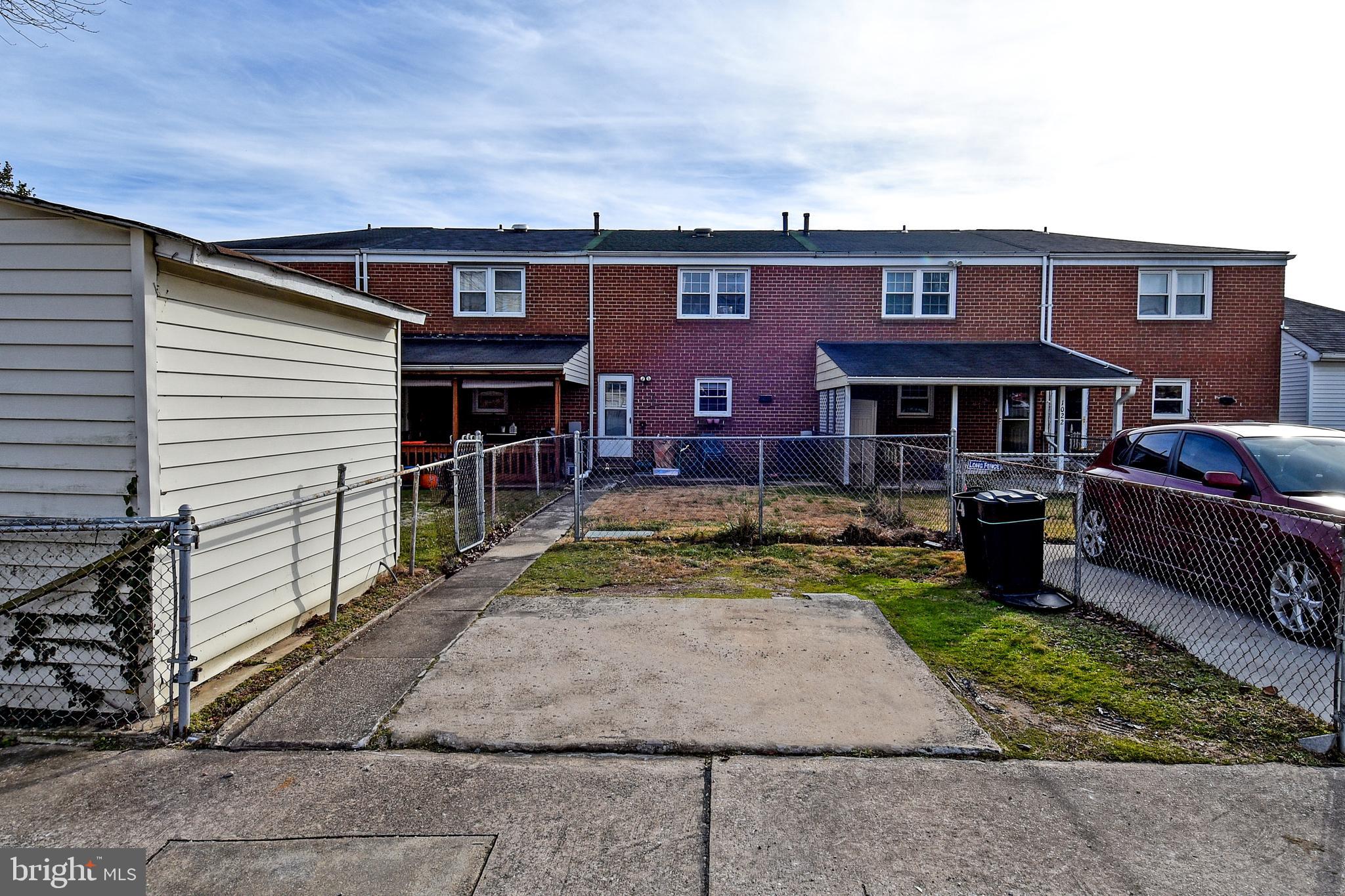 1024 Grovehill Road Baltimore, MD 21227 - Photo 38 of 39 a view of a house with a patio and a yard