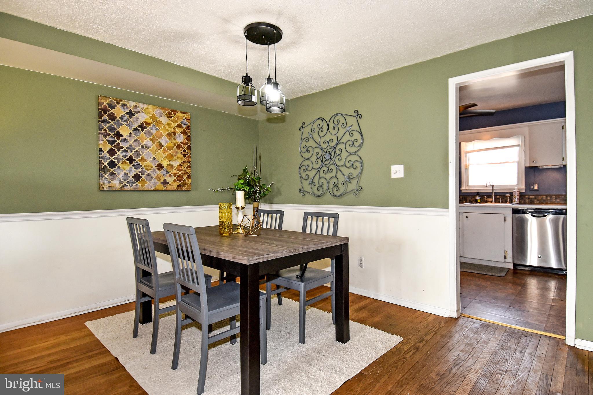 1024 Grovehill Road Baltimore, MD 21227 - Photo 6 of 39 a view of a dining room with furniture wooden floor and chandelier