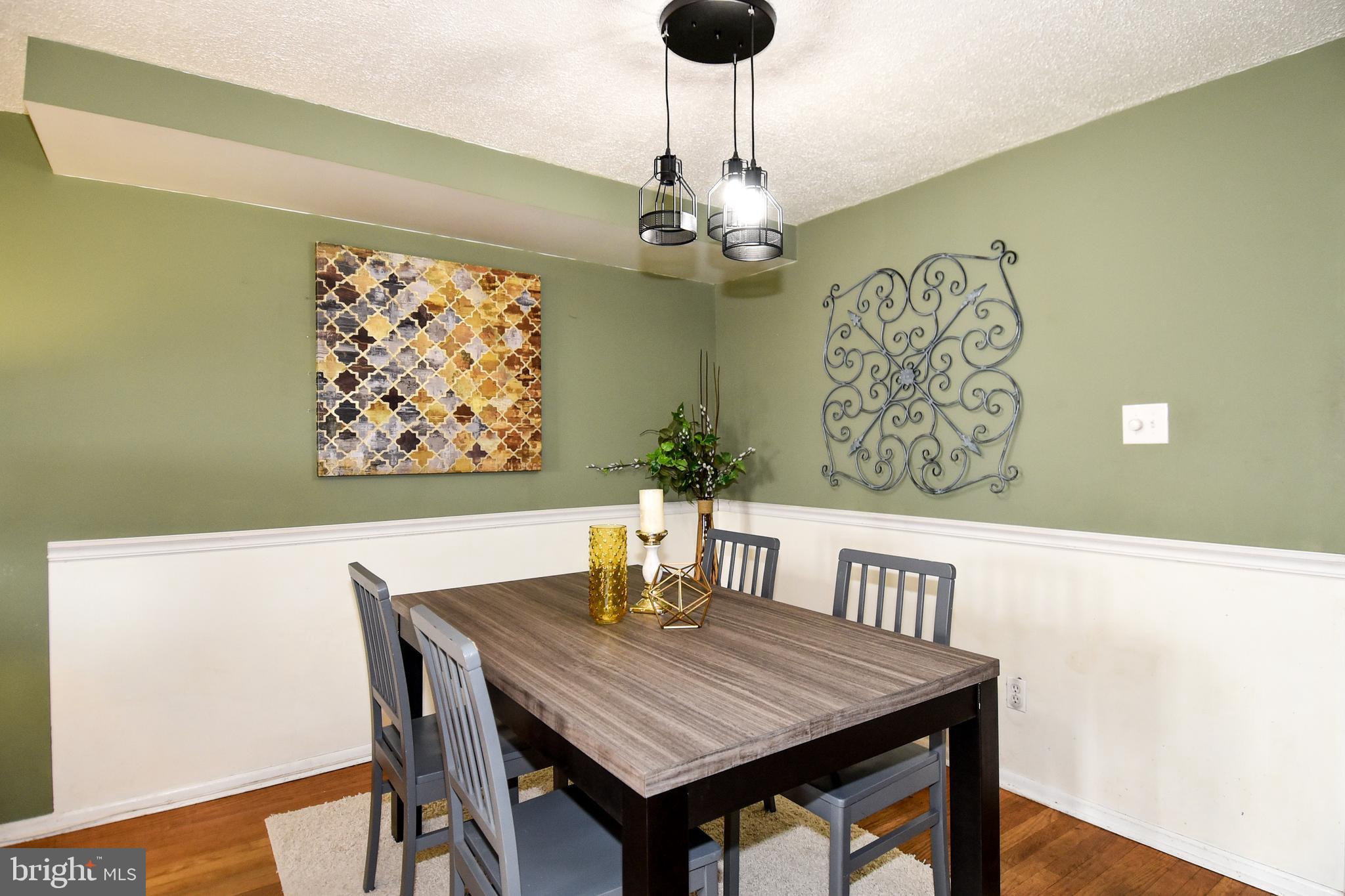 1024 Grovehill Road Baltimore, MD 21227 - Photo 7 of 39 a view of a dining room with furniture wooden floor and a chandelier