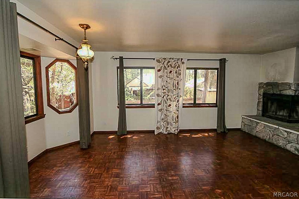 337 Maple Lane Sugarloaf, CA 92386 - Photo 12 of 25 a view of a room with wooden floor fireplace and windows