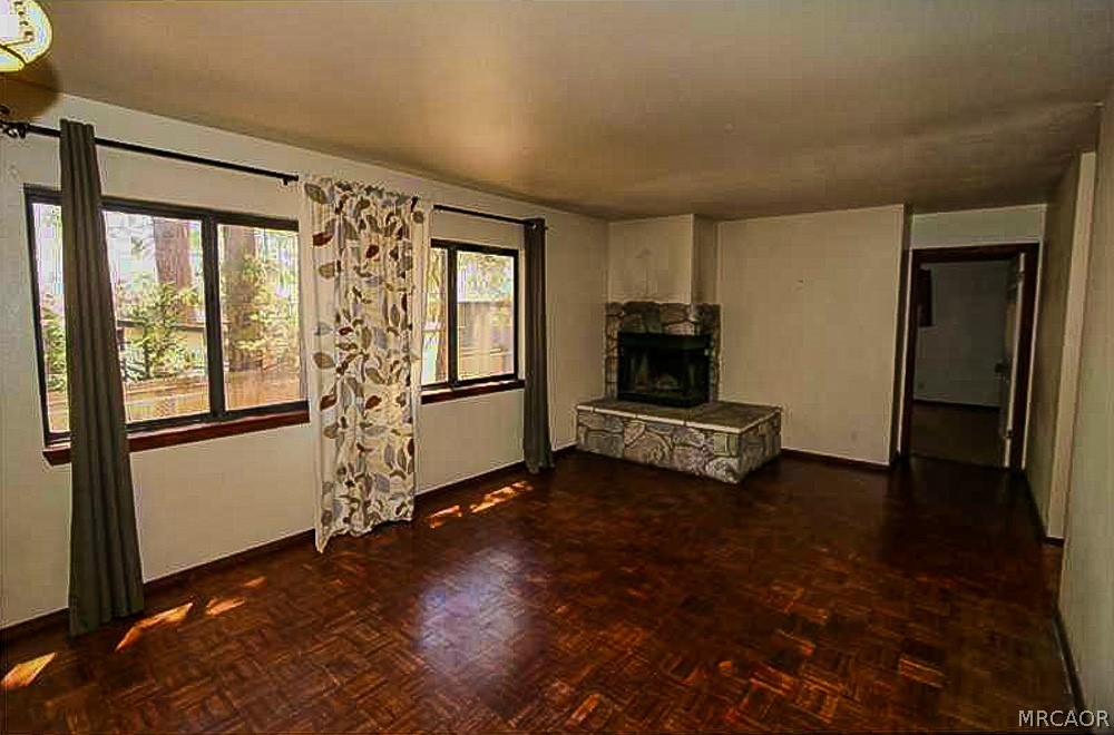 337 Maple Lane Sugarloaf, CA 92386 - Photo 14 of 25 a view of a livingroom with wooden floor and a window