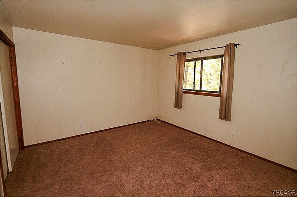 337 Maple Lane Sugarloaf, CA 92386 - Photo 17 of 25 an empty room with a window