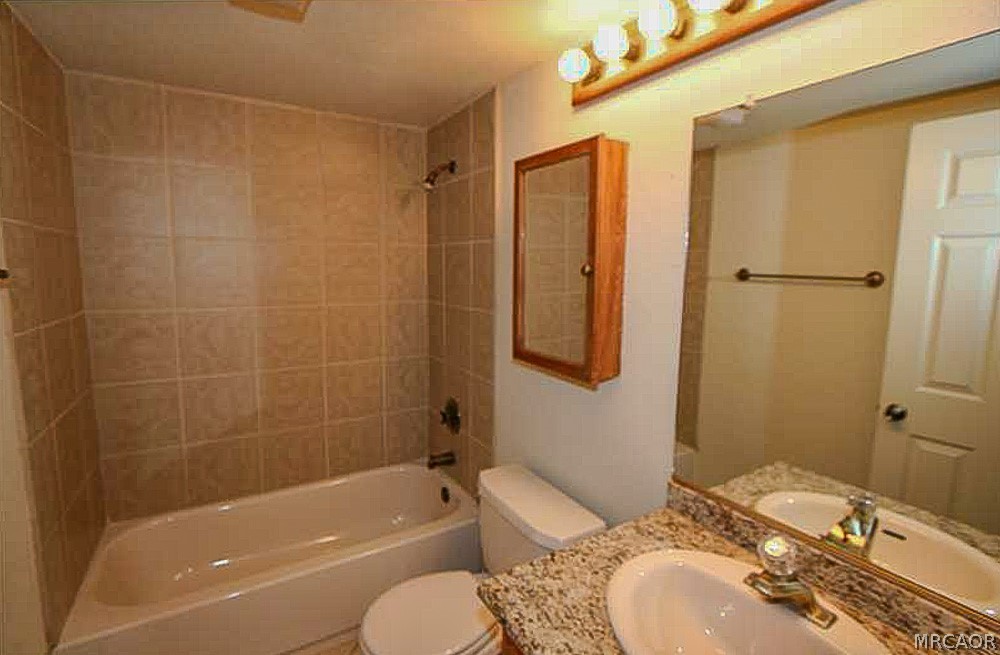 337 Maple Lane Sugarloaf, CA 92386 - Photo 20 of 25 a bathroom with a granite countertop bathtub shower sink vanity and toilet