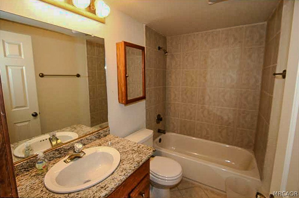337 Maple Lane Sugarloaf, CA 92386 - Photo 21 of 25 a bathroom with a granite countertop sink toilet mirror and shower
