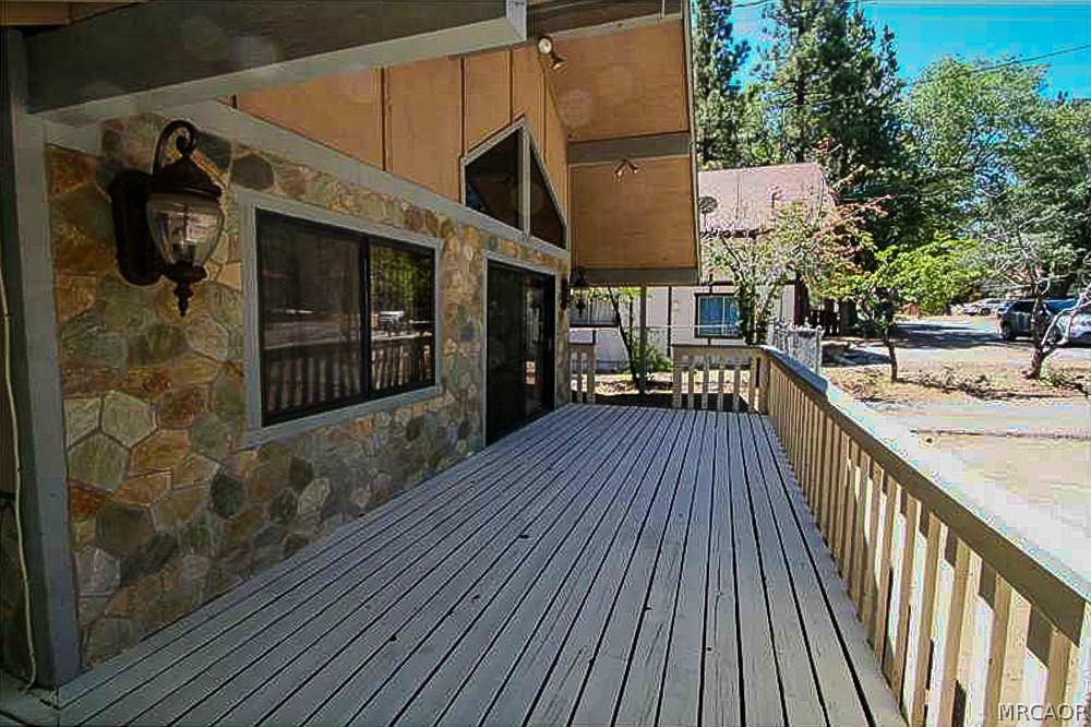 337 Maple Lane Sugarloaf, CA 92386 - Photo 23 of 25 a view of a house with a balcony and wooden floor