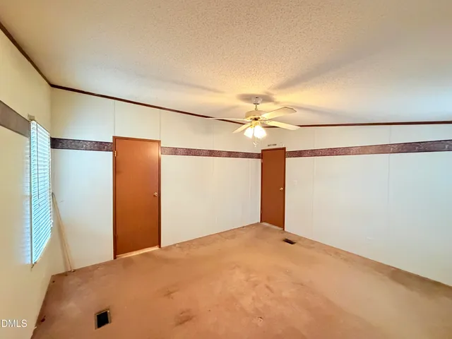 a view of a big room with closet and chandelier fan