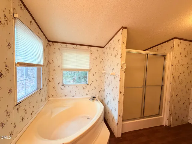 a bathroom with a tub a sink and a shower
