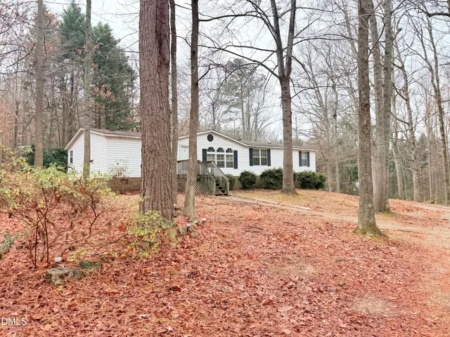 a view of a house with a yard covered in snow