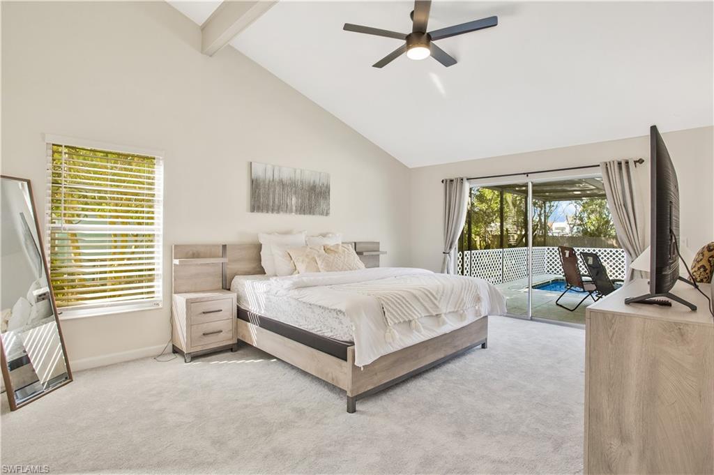 1039 Cardinal Street Naples, FL 34104 - Photo 15 of 29 a spacious bedroom with a bed and a flat tv screen on dresser
