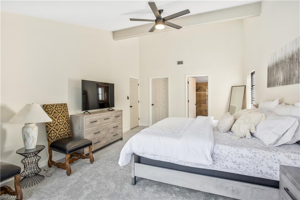 1039 Cardinal Street Naples, FL 34104 - Photo 16 of 29 a bedroom with a bed and a flat screen tv