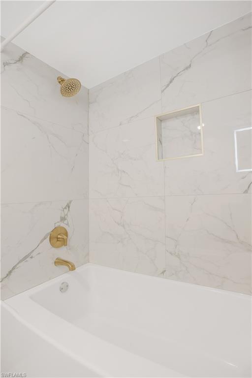 1039 Cardinal Street Naples, FL 34104 - Photo 22 of 29 a bathroom with a bathtub