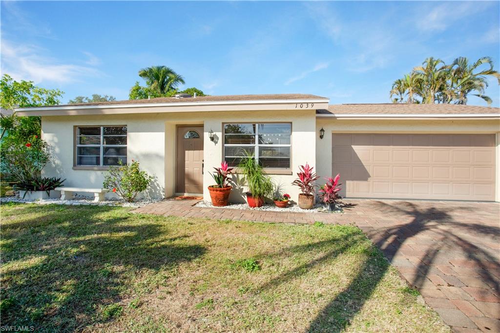 1039 Cardinal Street Naples, FL 34104 - Photo 29 of 29 front view of a house with a patio