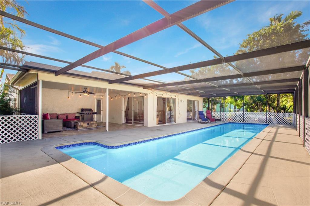 1039 Cardinal Street Naples, FL 34104 - Photo 3 of 29 a front view of a house with swing and slide