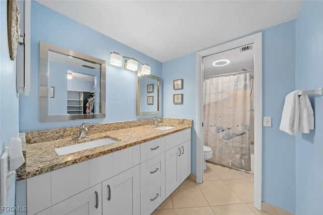 a spacious bathroom with a granite countertop sink mirror and a