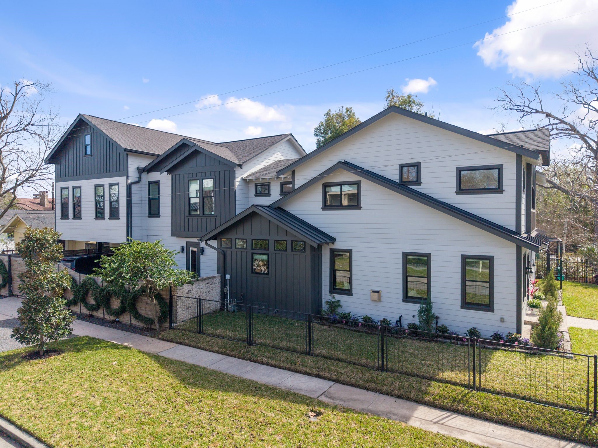 2626 Reagan Street Houston, TX 77009 - Photo 2 of 50 This side view of the home highlights its impressive scale, clean architectural lines, and prominent position on a spacious corner lot. It also sits on a quiet cul-de-sac perfect for kids to play and bike!