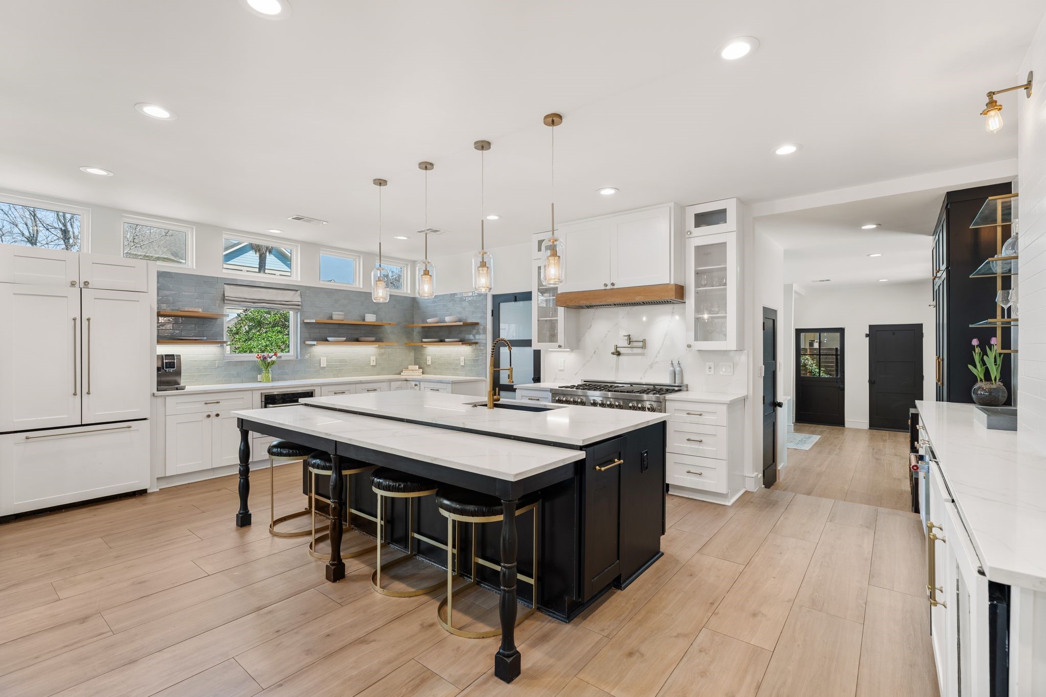 2626 Reagan Street Houston, TX 77009 - Photo 10 of 50 This view showcases the kitchen's full layout with abundant custom cabinetry and professional appliances. a panel front French door refrigerator with freezer drawer blends seamlessly with the cabinetry.