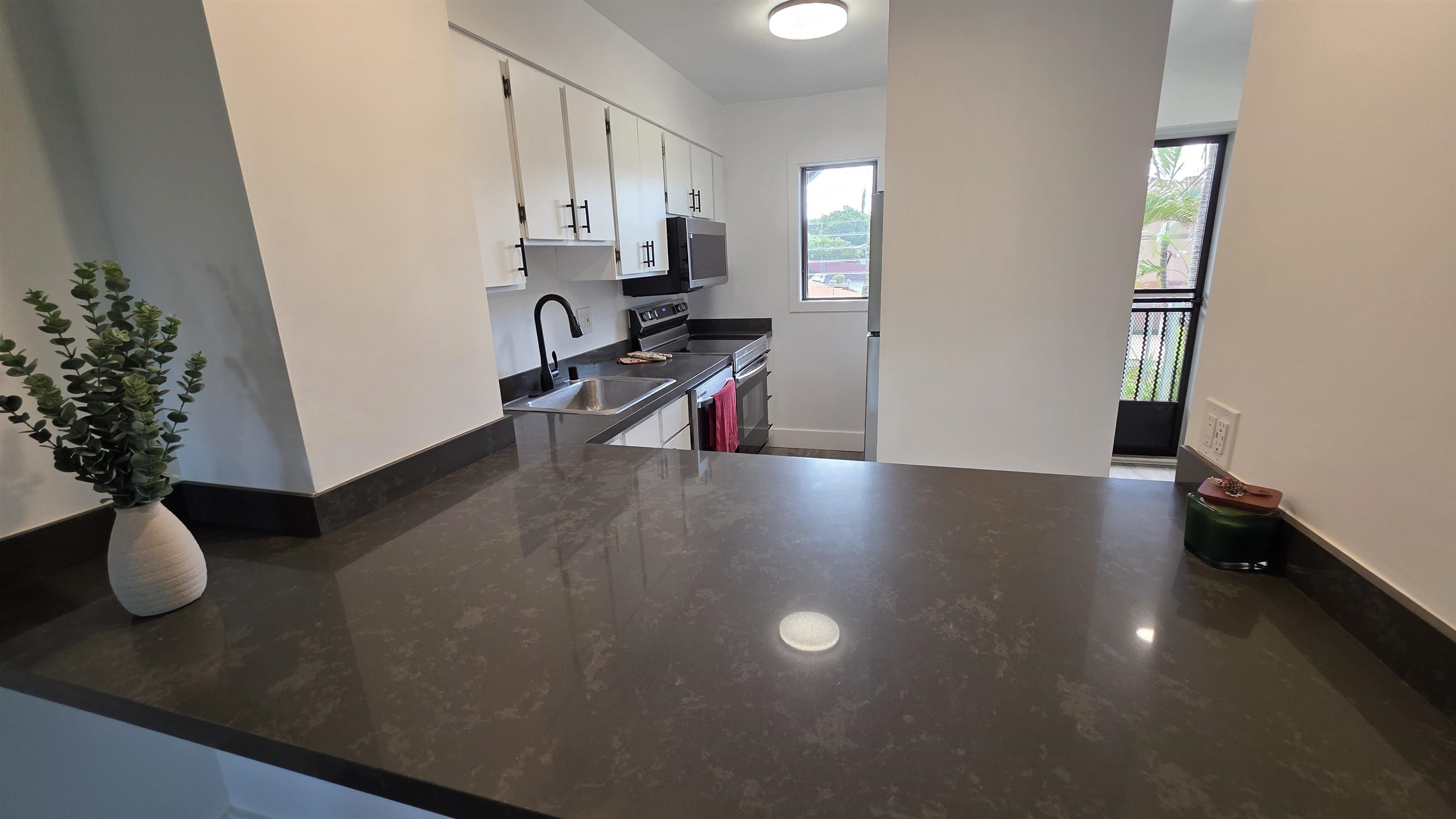 a view of livingroom with furniture and workspace