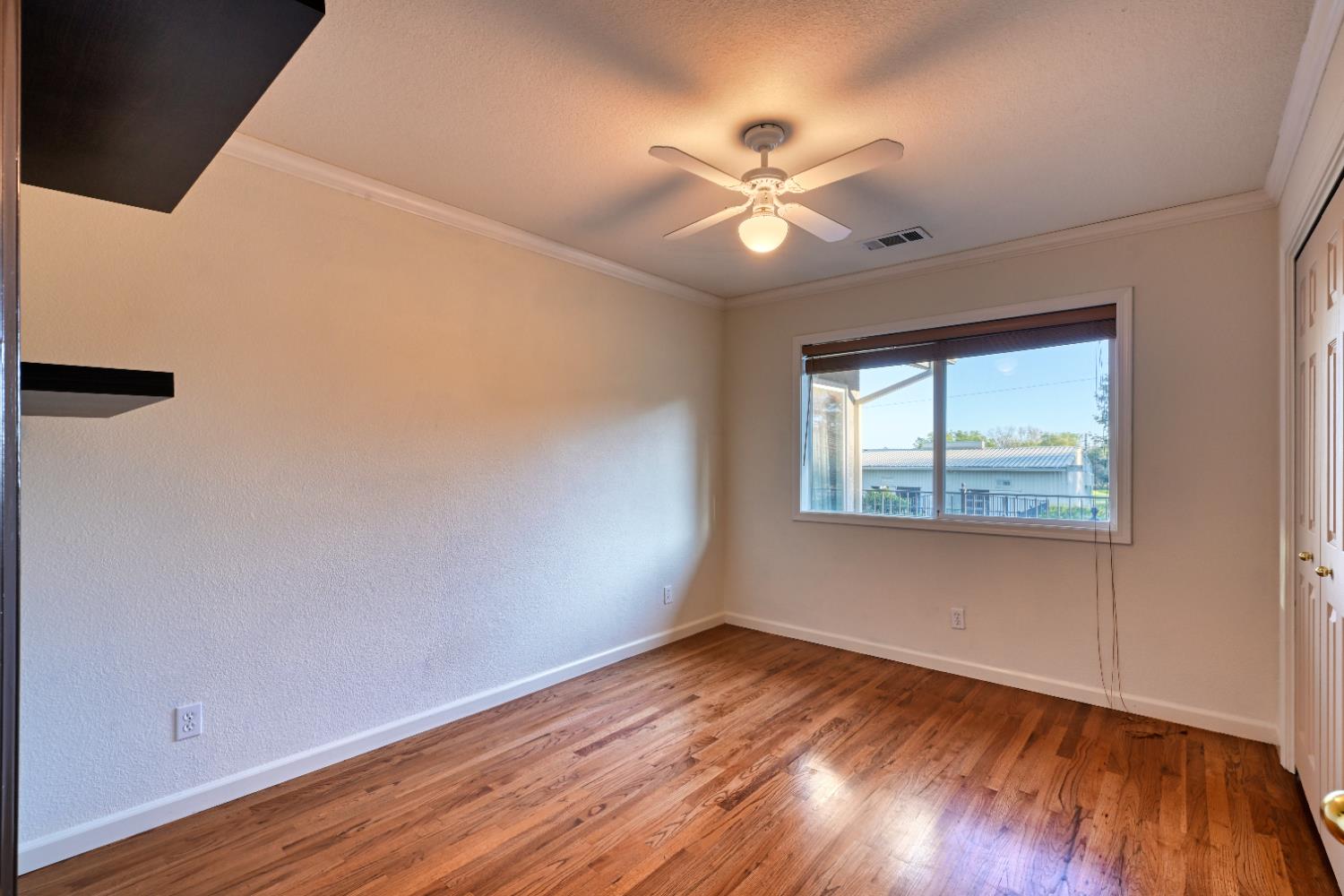 4841 Val Verde Road Loomis, CA 95650 - Photo 26 of 99 an empty room with wooden floor fan and windows