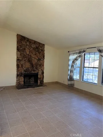 a view of an empty room with a fireplace