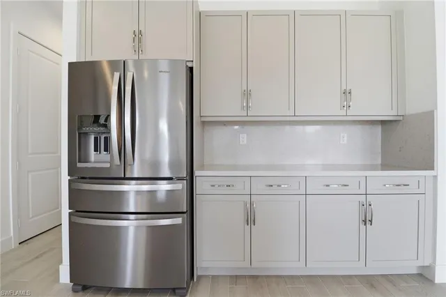 a kitchen with stainless steel appliances a refrigerator and a sink
