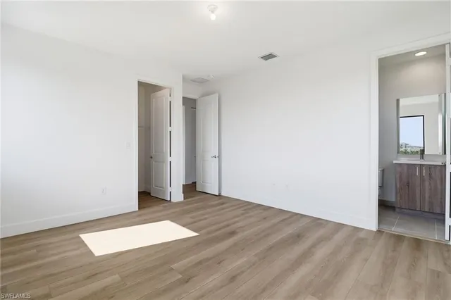 a view of an empty room with wooden floor