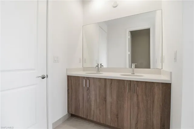 an empty room with wooden floor and bathroom