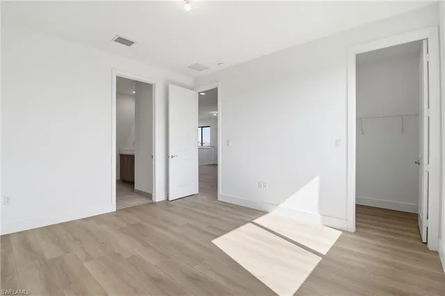 a view of an empty room and wooden floor