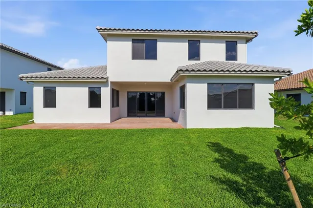 a utility room with cabinets washer and dryer