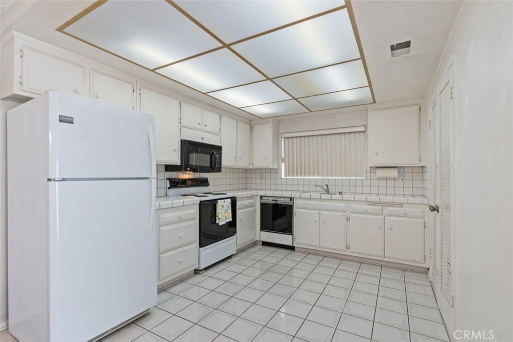 5081 Blackpool Road Westminster, CA 92683 - Photo 14 of 45 a kitchen with a stove sink and refrigerator