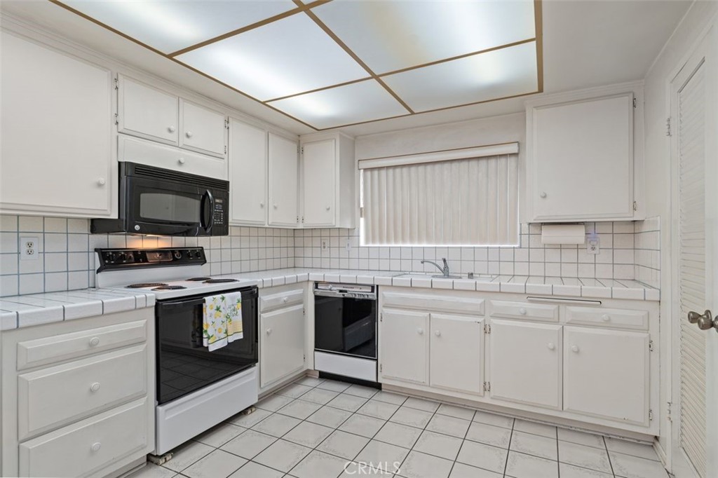 5081 Blackpool Road Westminster, CA 92683 - Photo 15 of 45 a kitchen with white cabinets appliances and sink