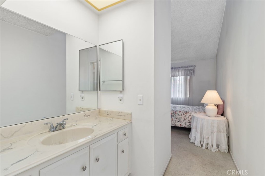 5081 Blackpool Road Westminster, CA 92683 - Photo 26 of 45 a en suite bathroom with a double vanity sink and a mirror