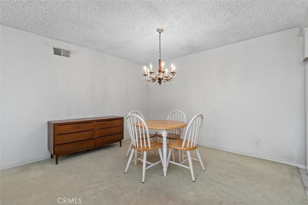 5081 Blackpool Road Westminster, CA 92683 - Photo 10 of 45 a view of a dining room with furniture and chandelier