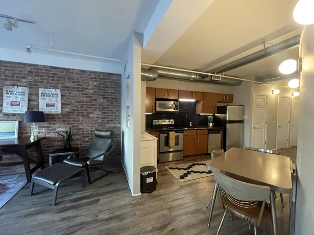 a dining room with furniture and wooden floor