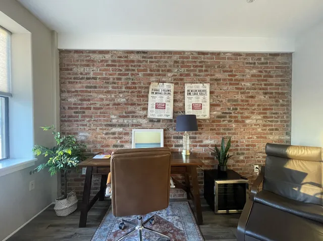 a dining room with table chairs and potted plants