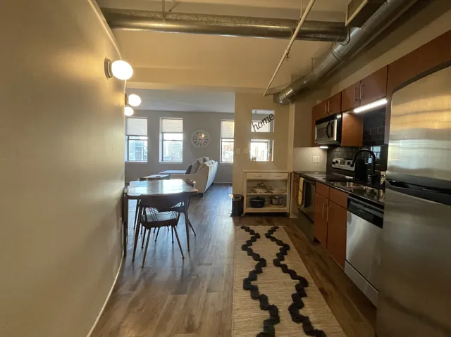 a kitchen with sink cabinets and stainless steel appliances