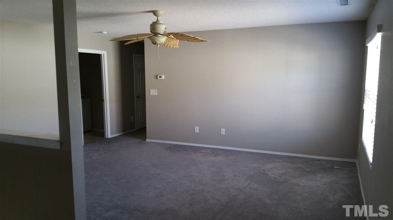 1004 Naylor Road Knightdale, NC 27545 - Photo 12 of 20 an empty room with windows and fan