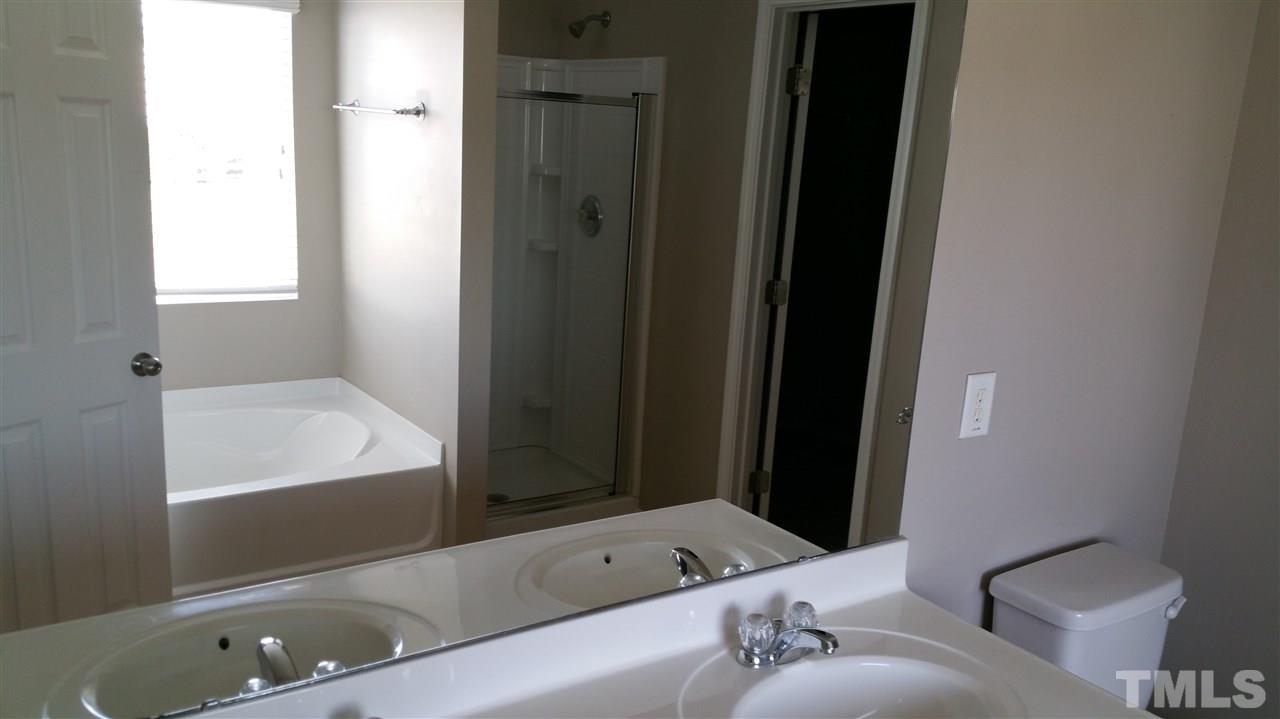1004 Naylor Road Knightdale, NC 27545 - Photo 15 of 20 a bathroom with a bathtub and a sink