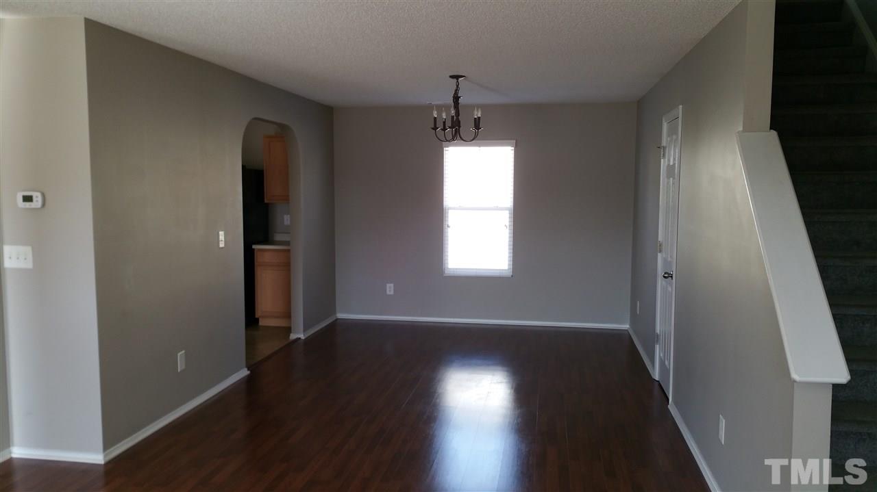 1004 Naylor Road Knightdale, NC 27545 - Photo 3 of 20 an empty room with wooden floor and windows