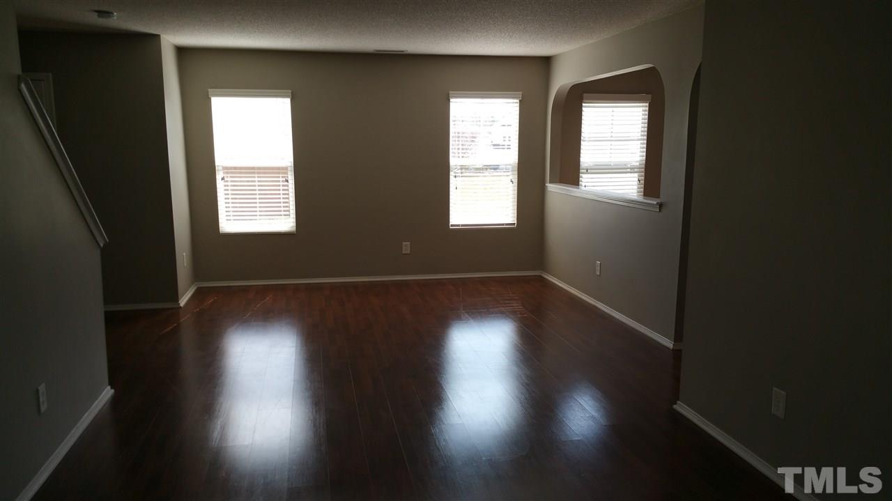 1004 Naylor Road Knightdale, NC 27545 - Photo 4 of 20 an empty room with wooden floor and windows