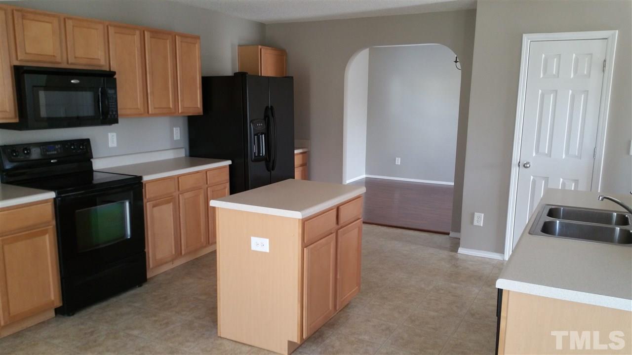 1004 Naylor Road Knightdale, NC 27545 - Photo 6 of 20 a kitchen with a refrigerator stove and sink