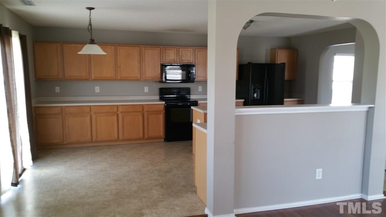 1004 Naylor Road Knightdale, NC 27545 - Photo 7 of 20 a kitchen with stainless steel appliances granite countertop a refrigerator and a sink